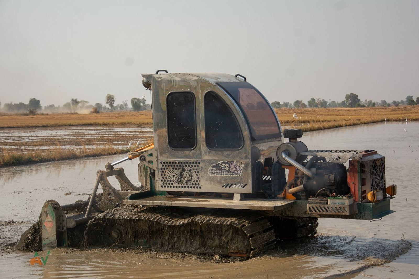 Crawler tractor working wet rice fields